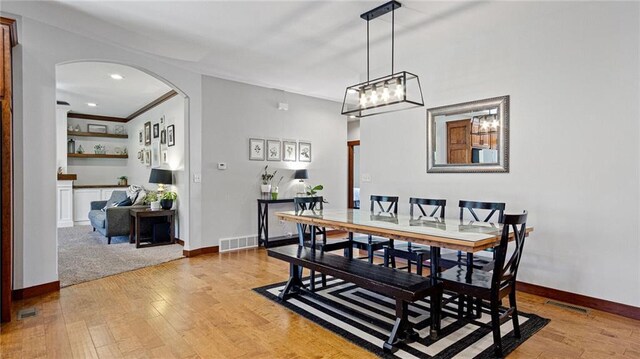 129 Grey Friar Ln, Eau Claire, WI 54701 - dining space with arched walkways, light wood-style flooring, baseboards, and recessed lighting