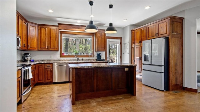 129 Grey Friar Ln, Eau Claire, WI 54701 - kitchen featuring stainless steel appliances, light stone countertops, light wood-type flooring, a center island, and recessed lighting