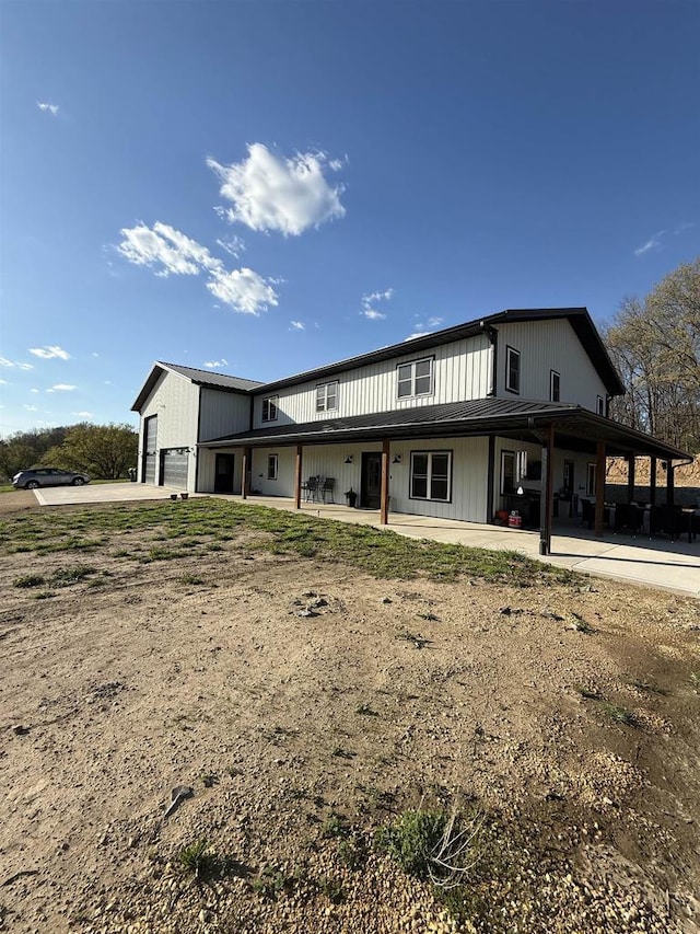 2515 County Road Hk, Barneveld, WI 53507 - back of house featuring a garage and concrete driveway