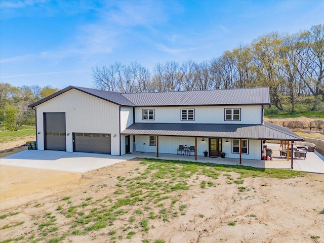 2515 County Road Hk, Barneveld, WI 53507 - modern farmhouse style home featuring dirt driveway, metal roof, and a garage