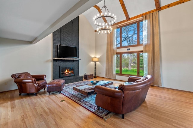 W343S9320 Jericho Dr, Eagle, WI 53119 - living area featuring high vaulted ceiling, a chandelier, wood finished floors, a brick fireplace, and beam ceiling