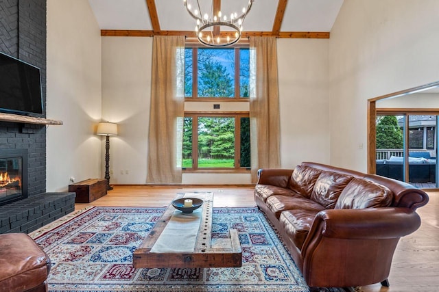 W343S9320 Jericho Dr, Eagle, WI 53119 - living room featuring high vaulted ceiling, a fireplace, plenty of natural light, a chandelier, and wood finished floors