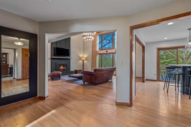 W343S9320 Jericho Dr, Eagle, WI 53119 - living room featuring healthy amount of natural light, light wood-type flooring, a chandelier, a fireplace, and recessed lighting