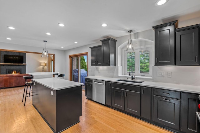 W343S9320 Jericho Dr, Eagle, WI 53119 - kitchen featuring a sink, dishwasher, a fireplace, plenty of natural light, and recessed lighting