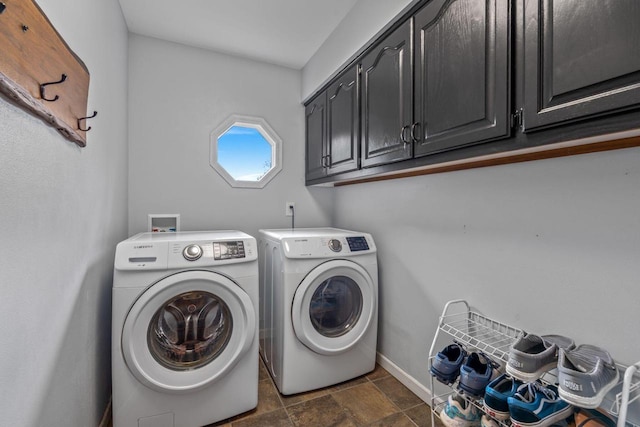 W343S9320 Jericho Dr, Eagle, WI 53119 - laundry area with cabinet space, washer and clothes dryer, baseboards, and dark stone finish floors