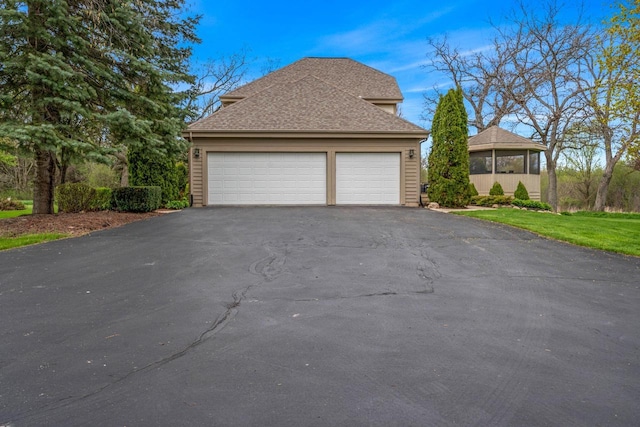 W343S9320 Jericho Dr, Eagle, WI 53119 - view of side of home featuring asphalt driveway, a garage, and roof with shingles