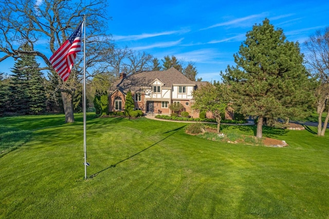 W343S9320 Jericho Dr, Eagle, WI 53119 - view of front of property featuring a front lawn, stucco siding, and a chimney
