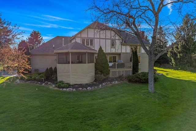 W343S9320 Jericho Dr, Eagle, WI 53119 - rear view of property with a lawn, a shingled roof, a chimney, and a deck