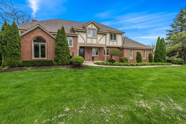 W343S9320 Jericho Dr, Eagle, WI 53119 - english style home featuring brick siding, a front lawn, a chimney, and a shingled roof