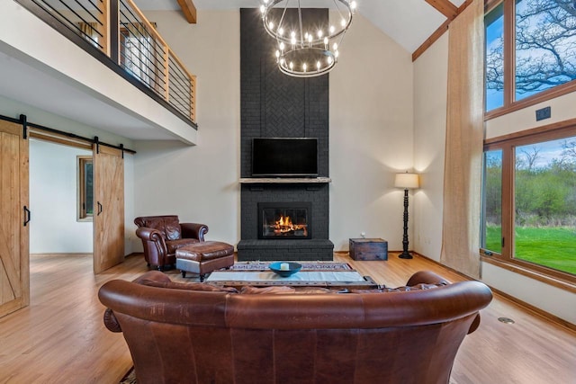 W343S9320 Jericho Dr, Eagle, WI 53119 - living room featuring high vaulted ceiling, a brick fireplace, a chandelier, wood finished floors, and beamed ceiling