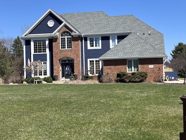 628 Sedge Meadow Ct, Summit, WI 53066 - view of front of property featuring a front yard, a shingled roof, and brick siding