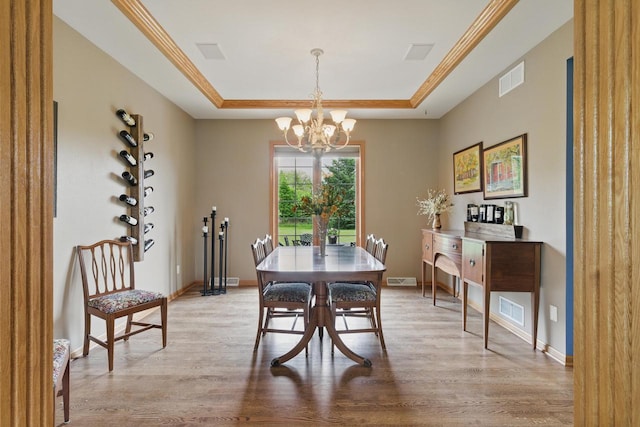 628 Sedge Meadow Ct, Summit, WI 53066 - dining space featuring a tray ceiling, a chandelier, wood finished floors, and baseboards