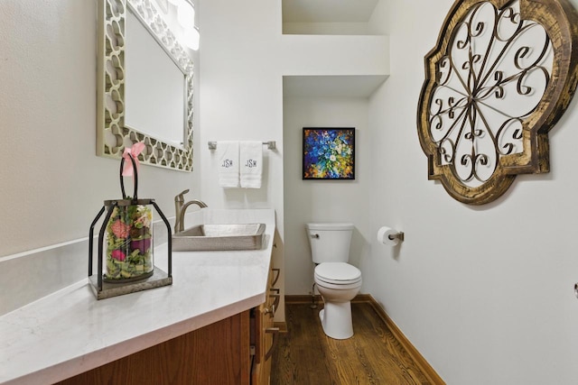 628 Sedge Meadow Ct, Summit, WI 53066 - bathroom featuring wood finished floors, toilet, baseboards, and vanity