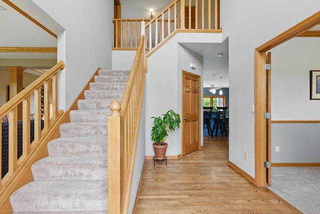 628 Sedge Meadow Ct, Summit, WI 53066 - stairs featuring wood finished floors, baseboards, and a towering ceiling