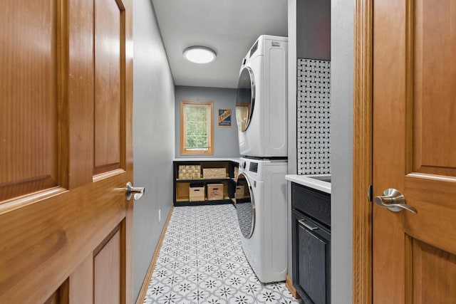 628 Sedge Meadow Ct, Summit, WI 53066 - laundry room with stacked washing machine and dryer, cabinet space, and baseboards