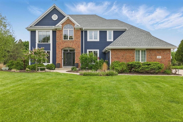 628 Sedge Meadow Ct, Summit, WI 53066 - view of front of home with a front lawn, brick siding, and a shingled roof