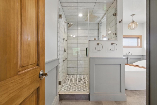 628 Sedge Meadow Ct, Summit, WI 53066 - full bathroom featuring a shower stall, a freestanding bath, and tile patterned floors