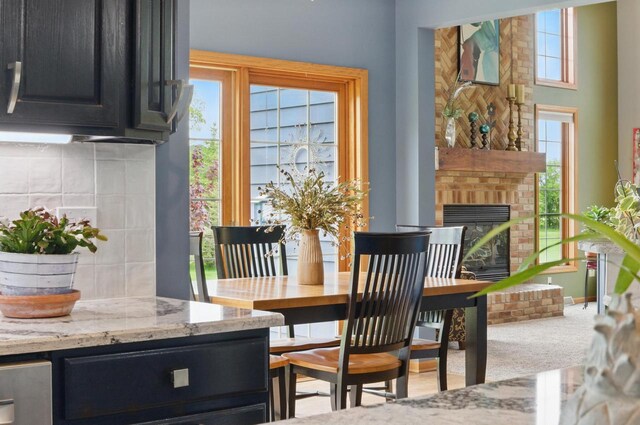 628 Sedge Meadow Ct, Summit, WI 53066 - dining area with healthy amount of natural light, a brick fireplace, and carpet floors