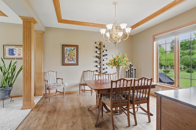 628 Sedge Meadow Ct, Summit, WI 53066 - dining room with a raised ceiling, light wood-style floors, a chandelier, baseboards, and decorative columns