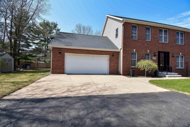 3001 Revere Rd, Plover, WI 54406 - view of front of home featuring a garage, concrete driveway, a front yard, and brick siding