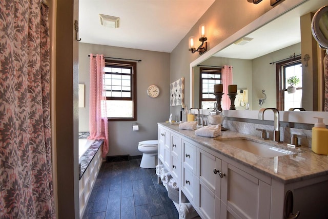 3001 Revere Rd, Plover, WI 54406 - full bath featuring healthy amount of natural light, toilet, and wood finished floors