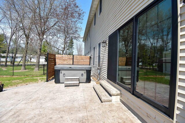 3001 Revere Rd, Plover, WI 54406 - view of patio / terrace featuring a hot tub and fence