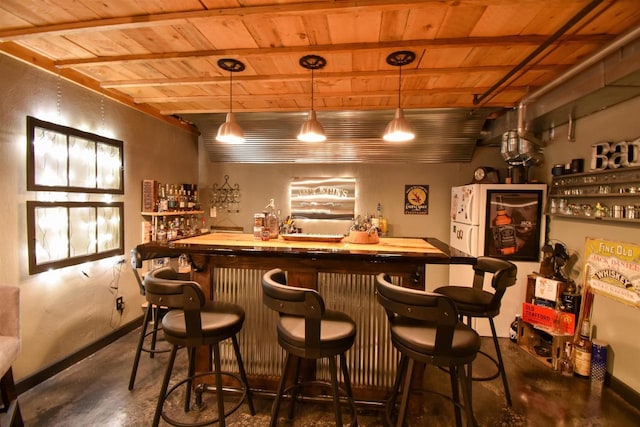 3001 Revere Rd, Plover, WI 54406 - indoor wet bar featuring wooden ceiling, concrete flooring, beam ceiling, and pendant lighting