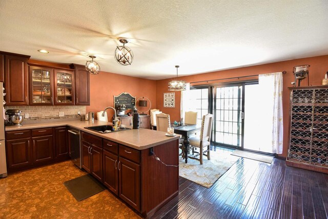 3001 Revere Rd, Plover, WI 54406 - kitchen featuring a sink, stainless steel dishwasher, a peninsula, light countertops, and glass insert cabinets