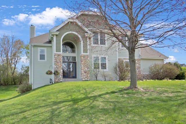 N53W16789 Prairie Dawn, Menomonee Falls, WI 53051 - traditional-style home featuring a chimney, a front yard, and stone siding