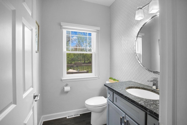 N53W16789 Prairie Dawn, Menomonee Falls, WI 53051 - half bath featuring wood finished floors, toilet, vanity, and baseboards
