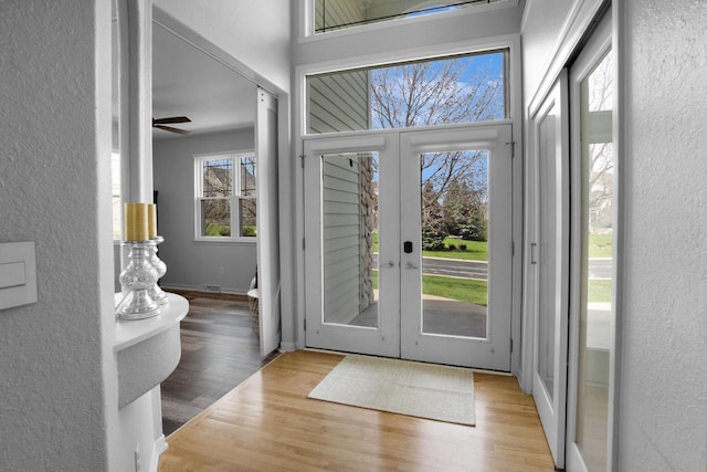 N53W16789 Prairie Dawn, Menomonee Falls, WI 53051 - foyer featuring wood finished floors, a textured wall, and french doors