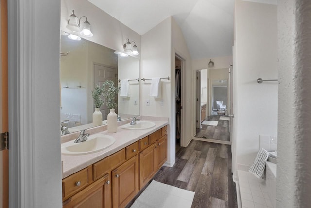 N53W16789 Prairie Dawn, Menomonee Falls, WI 53051 - full bathroom with double vanity, lofted ceiling, and wood finished floors
