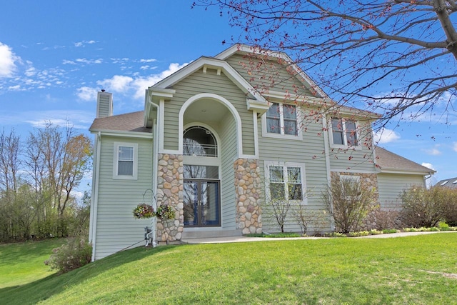 N53W16789 Prairie Dawn, Menomonee Falls, WI 53051 - view of front facade with a chimney, a front lawn, and a shingled roof