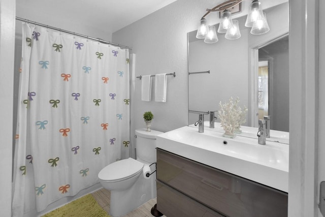 N53W16789 Prairie Dawn, Menomonee Falls, WI 53051 - full bath featuring toilet, vanity, curtained shower, and a textured wall