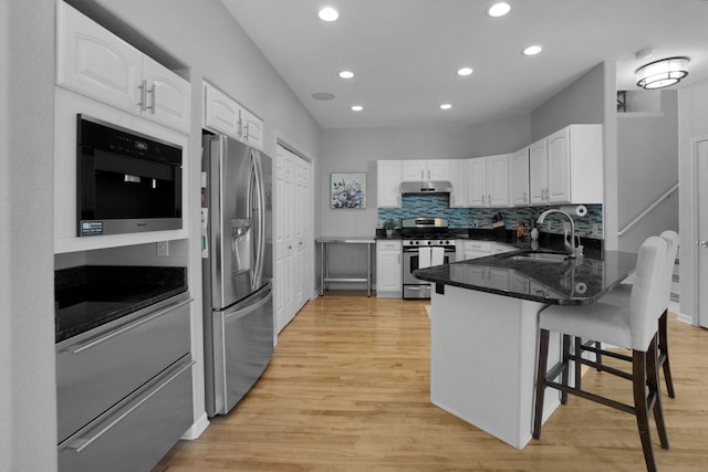 N53W16789 Prairie Dawn, Menomonee Falls, WI 53051 - kitchen featuring appliances with stainless steel finishes, a sink, a peninsula, white cabinetry, and recessed lighting