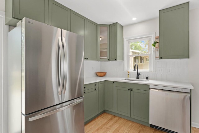 4516 Maher Ave, Madison, WI 53716 - kitchen with stainless steel appliances, green cabinets, a sink, light countertops, and recessed lighting