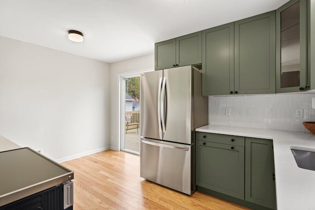 4516 Maher Ave, Madison, WI 53716 - kitchen with freestanding refrigerator, green cabinetry, light wood finished floors, and light countertops