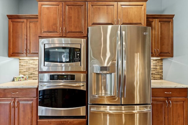 805 Mourning Dove Dr, Cottage Grove, WI 53527 - kitchen featuring appliances with stainless steel finishes, tasteful backsplash, and light stone counters