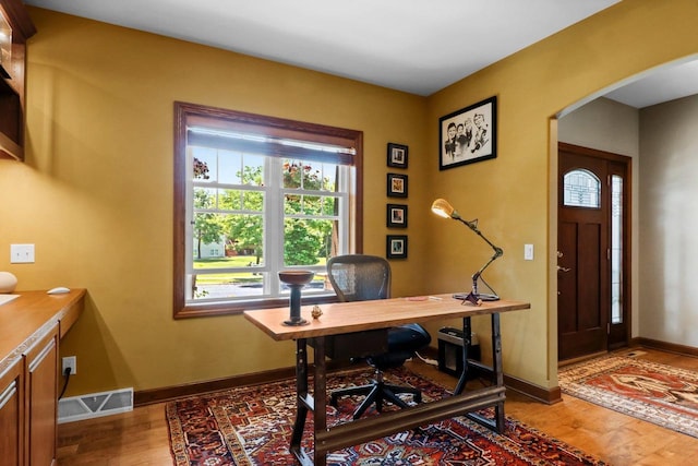 805 Mourning Dove Dr, Cottage Grove, WI 53527 - home office with arched walkways, healthy amount of natural light, and wood finished floors
