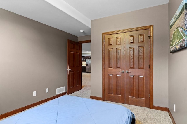 805 Mourning Dove Dr, Cottage Grove, WI 53527 - bedroom featuring stainless steel fridge, a closet, and carpet floors
