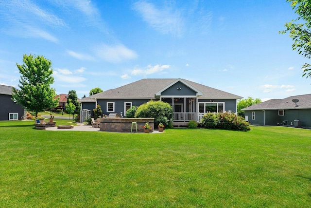 805 Mourning Dove Dr, Cottage Grove, WI 53527 - rear view of property featuring an outdoor fire pit, a sunroom, a lawn, and a shingled roof