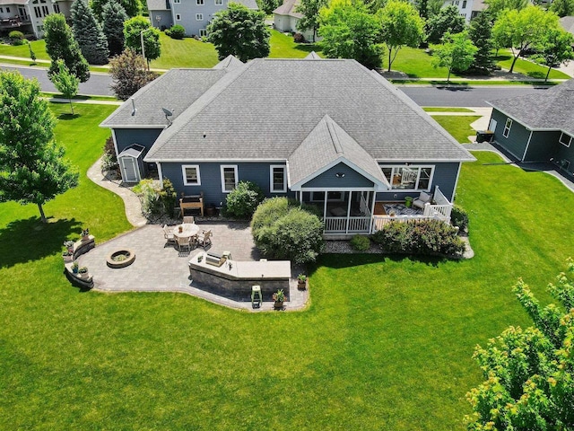 805 Mourning Dove Dr, Cottage Grove, WI 53527 - back of house featuring an outdoor fire pit, roof with shingles, and a yard