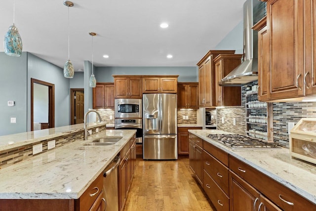 805 Mourning Dove Dr, Cottage Grove, WI 53527 - kitchen featuring stainless steel appliances, wall chimney range hood, backsplash, light wood-style flooring, and light stone countertops