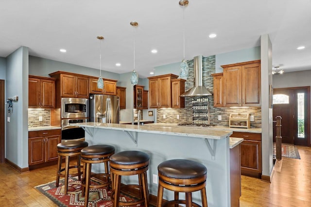 805 Mourning Dove Dr, Cottage Grove, WI 53527 - kitchen with stainless steel appliances, light wood-type flooring, backsplash, a kitchen bar, and recessed lighting