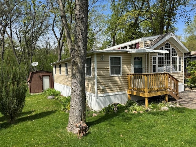 463 Aspen Way, Edgerton, WI 53534 - rear view of house with a shed, a deck, a lawn, and an outdoor structure