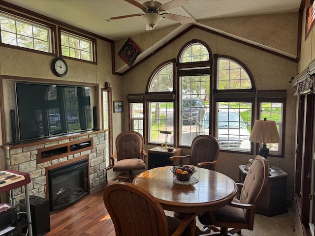 463 Aspen Way, Edgerton, WI 53534 - dining space featuring a ceiling fan, a fireplace, healthy amount of natural light, and high vaulted ceiling