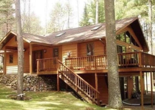N11894 E Deer Lake Rd, Tomahawk, WI 54487 - back of house featuring stairway, a yard, and a wooden deck
