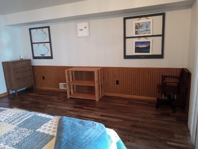 N11894 E Deer Lake Rd, Tomahawk, WI 54487 - bedroom with wainscoting, wood finished floors, and wooden walls