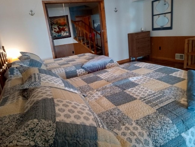 N11894 E Deer Lake Rd, Tomahawk, WI 54487 - bedroom with wainscoting, a closet, wood walls, and wood finished floors