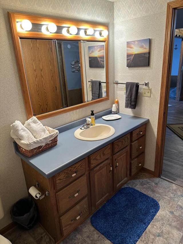 N11894 E Deer Lake Rd, Tomahawk, WI 54487 - bathroom featuring vanity, baseboards, and wallpapered walls
